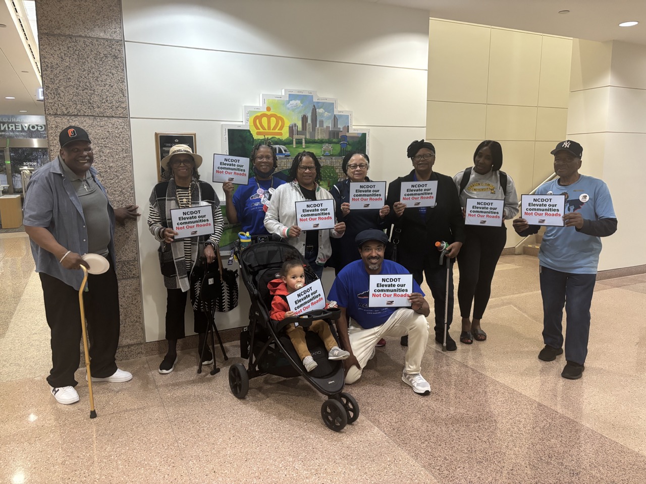 SWAN senior members standing together at a civic advocacy event, holding signs.