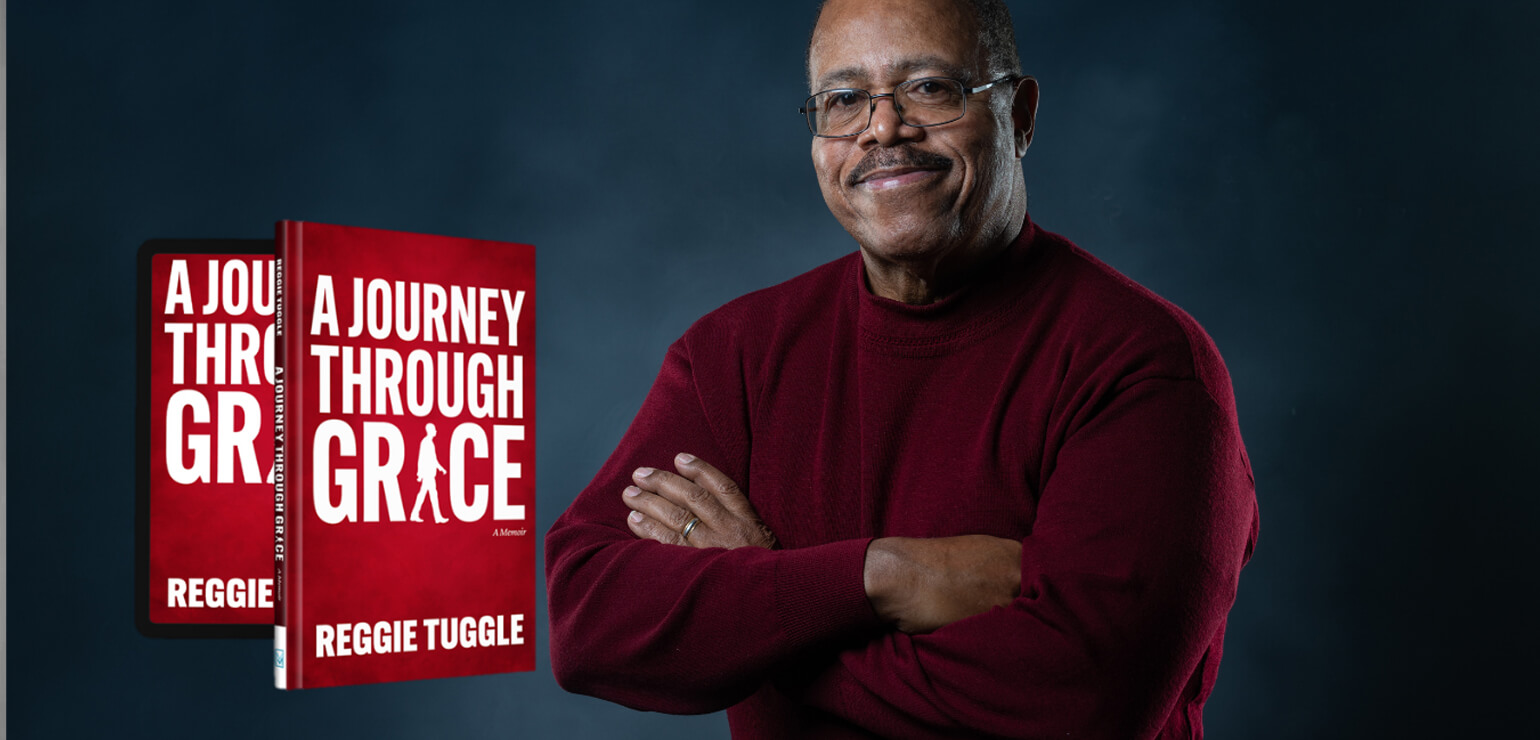 Rev. Reggie Tuggle with his book, A Journey Through Grace.